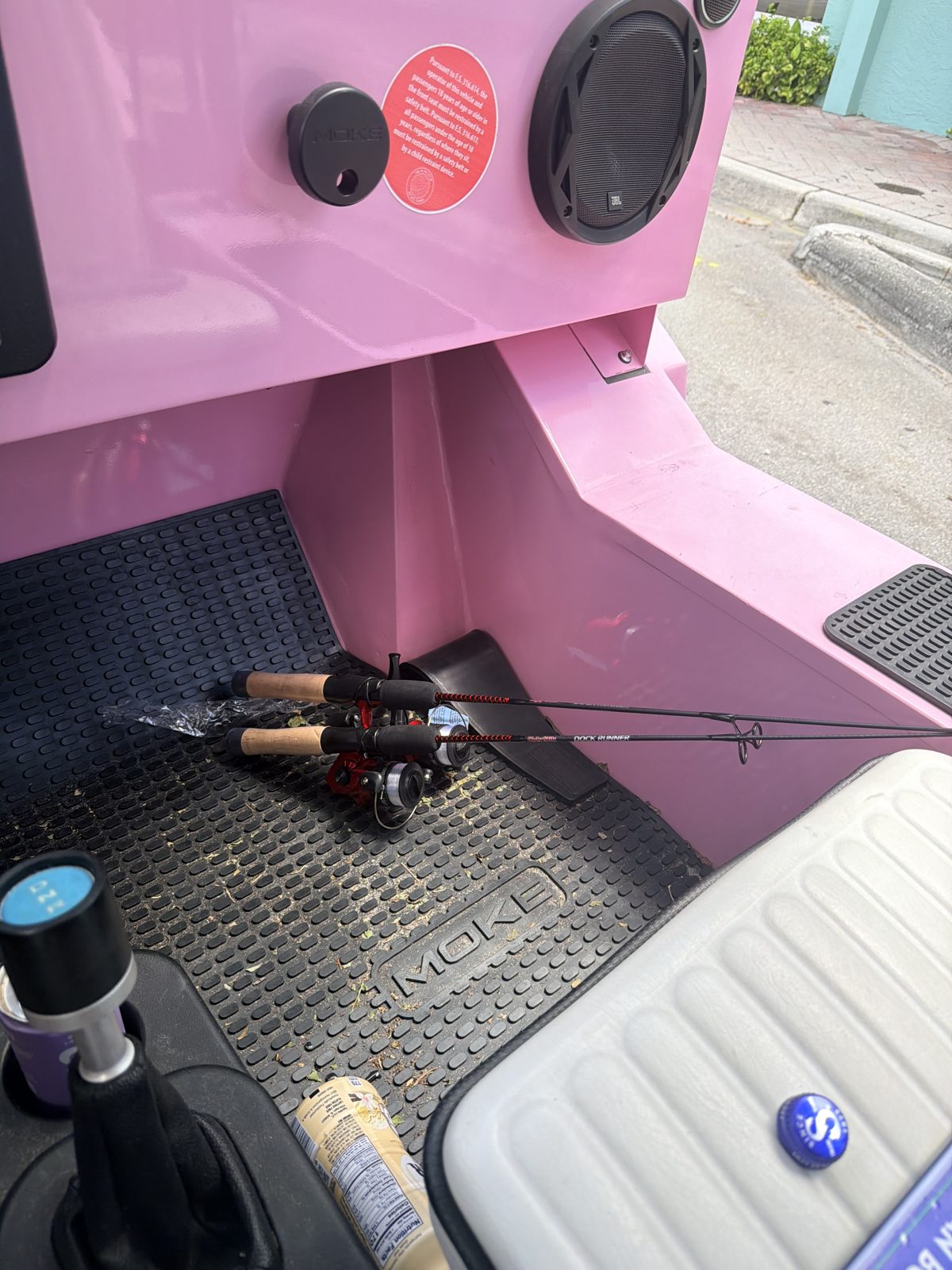 Pink Panther Moke interior — genuine MOKE key, JBL marine speakers, and fishing rods ready to go
